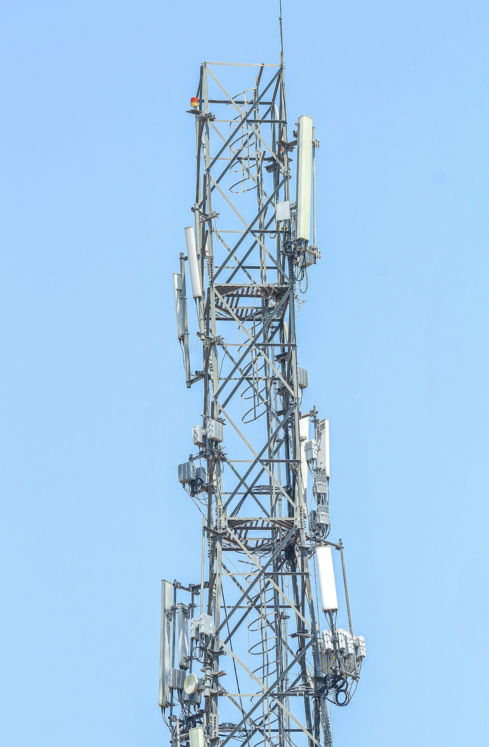a very tall tower with lots of antennas on top of it